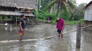 two people standing in the aftermath of a king tide