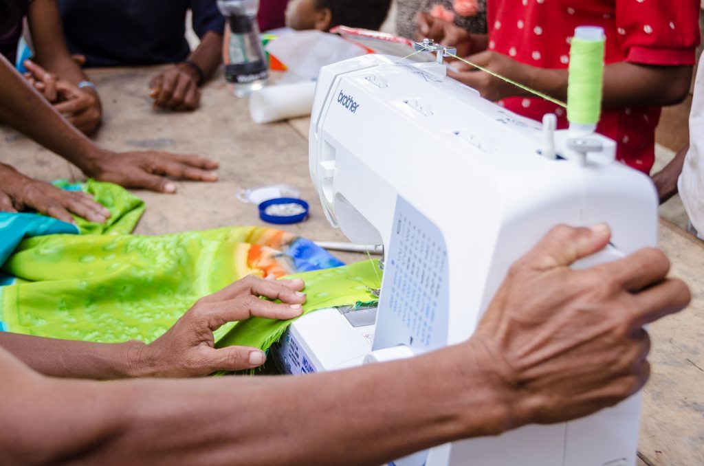 close up on a sewing machine being used by a person