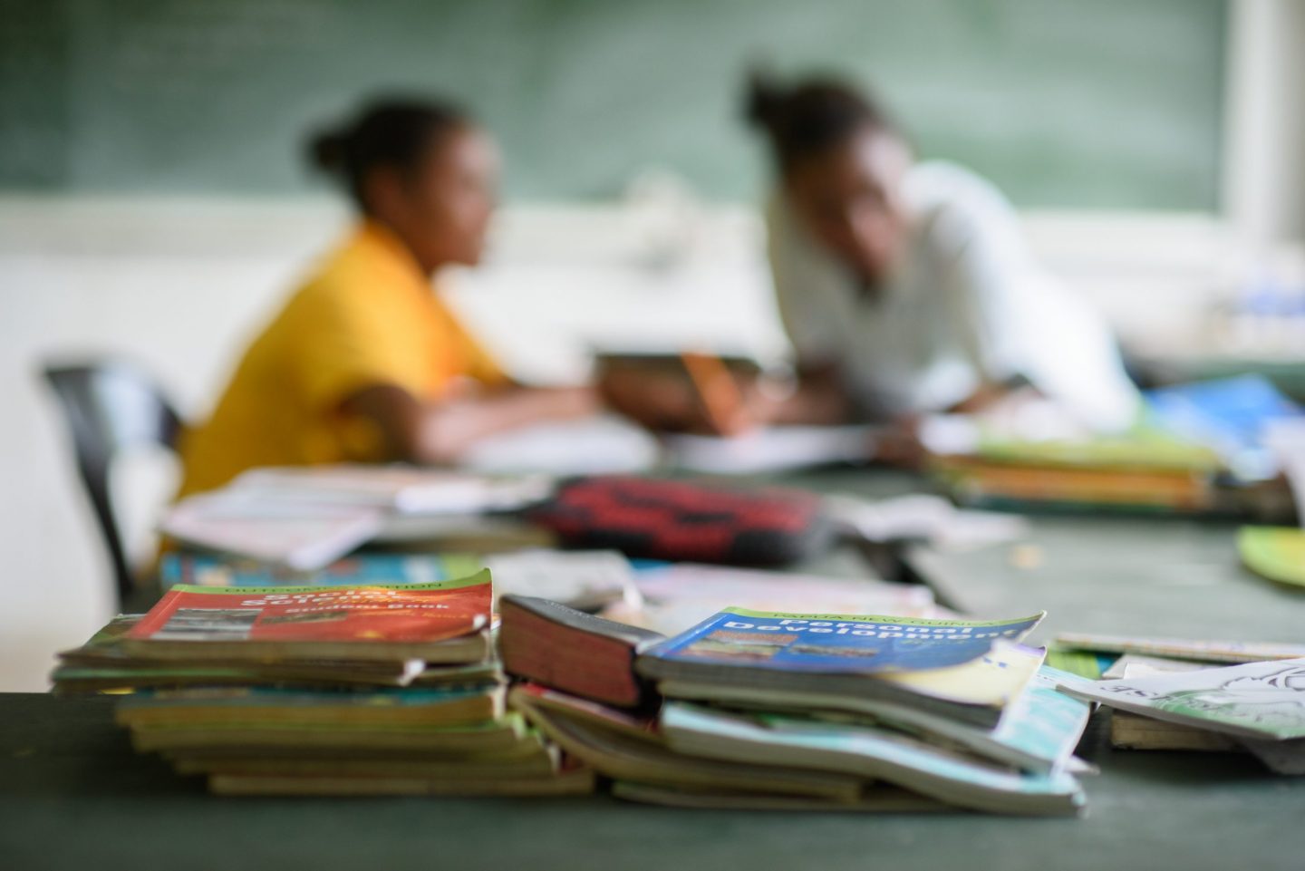 Teacher and pupil during lessons at school in Papua New Guinea