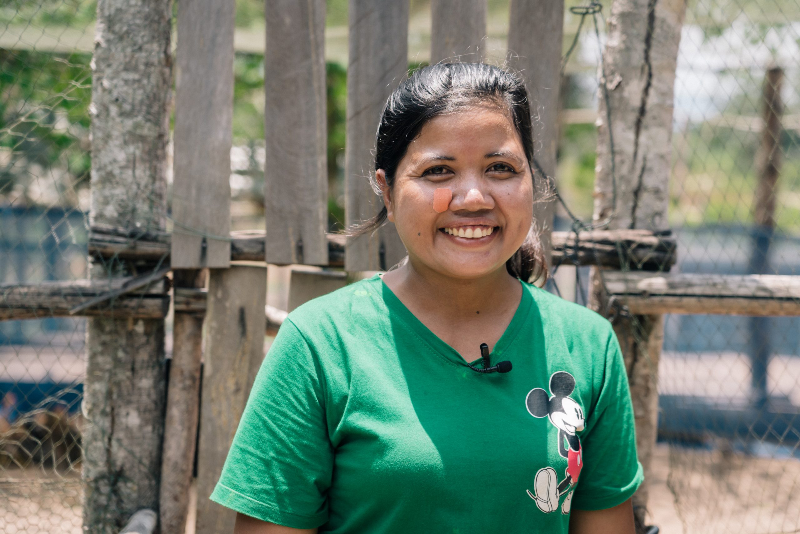 close up of a smiling woman in green t-shirt