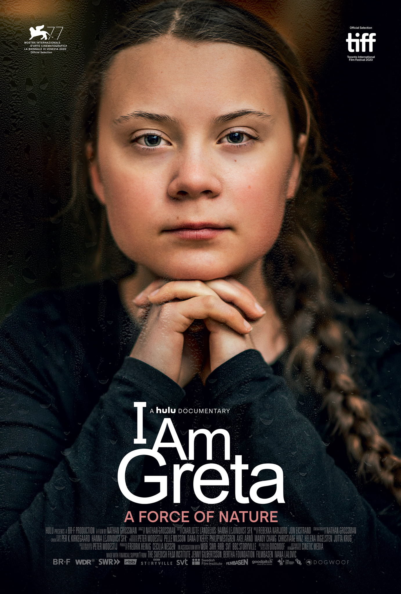 A film poster for the documentary I Am Greta, with a portrait of Greta Thunberg looking at the camera, resting her head on her interlocked fingers. The words I Am Greta: A force of nature appear over the image.