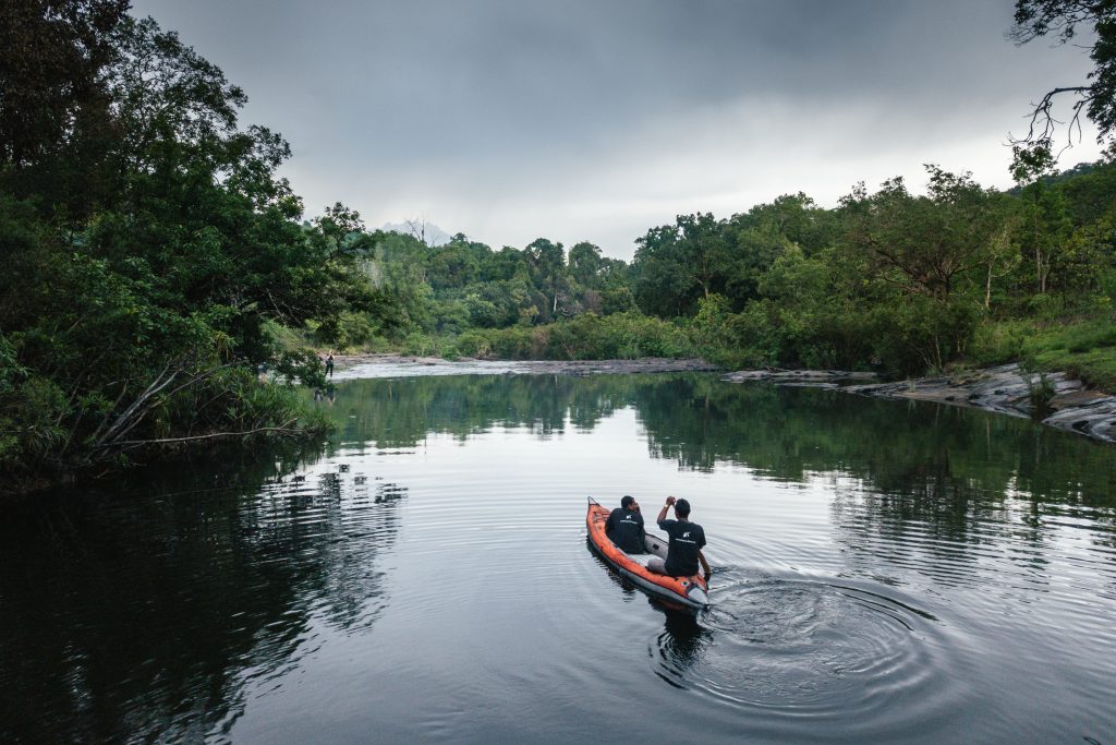 Crocodile wardens keep watch on their daily river patrol.