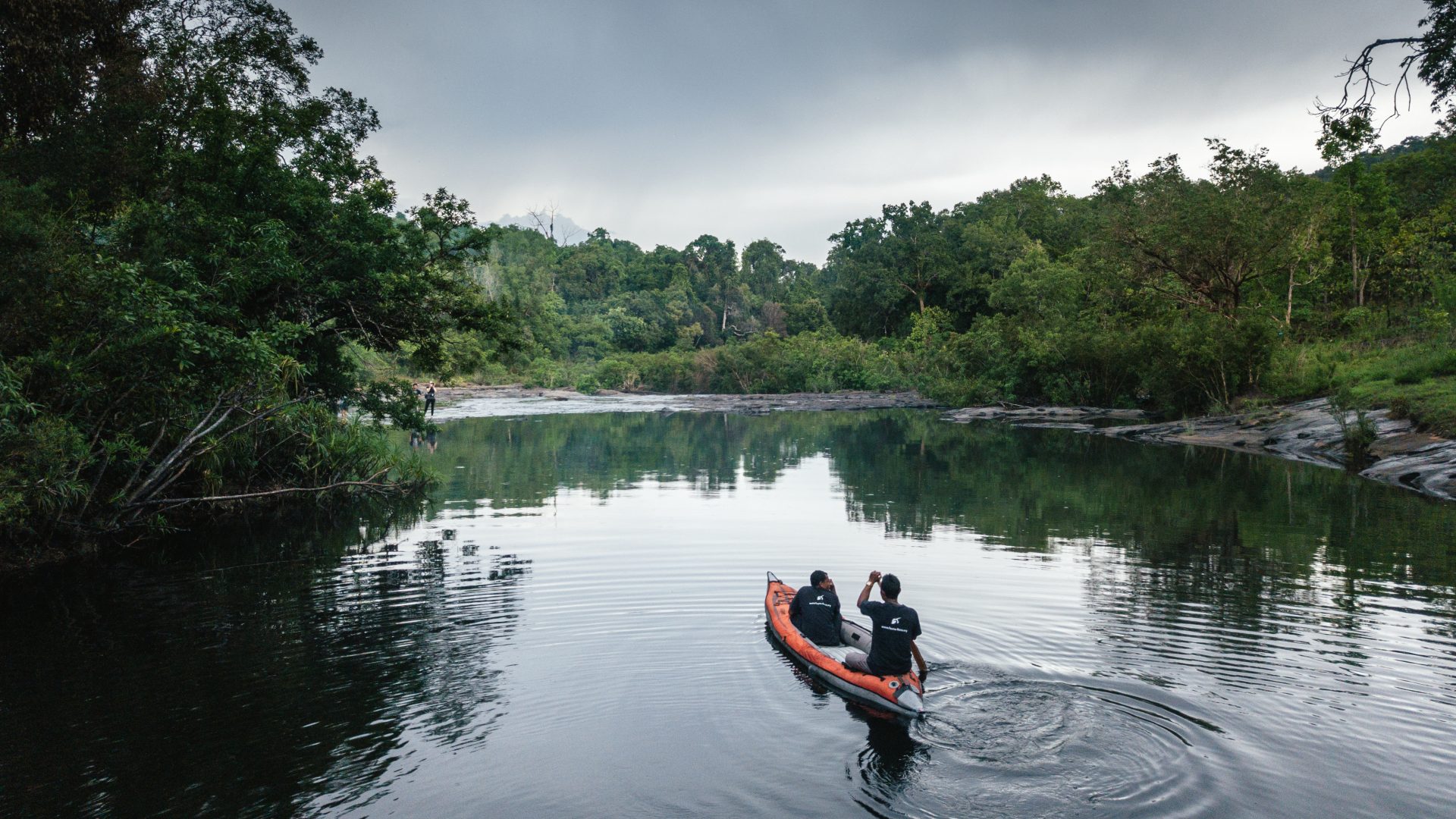 Crocodile wardens keep watch on their daily river patrol.