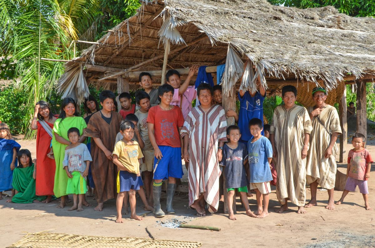 Members, including adults and children of Asháninka community smiling for a group photo