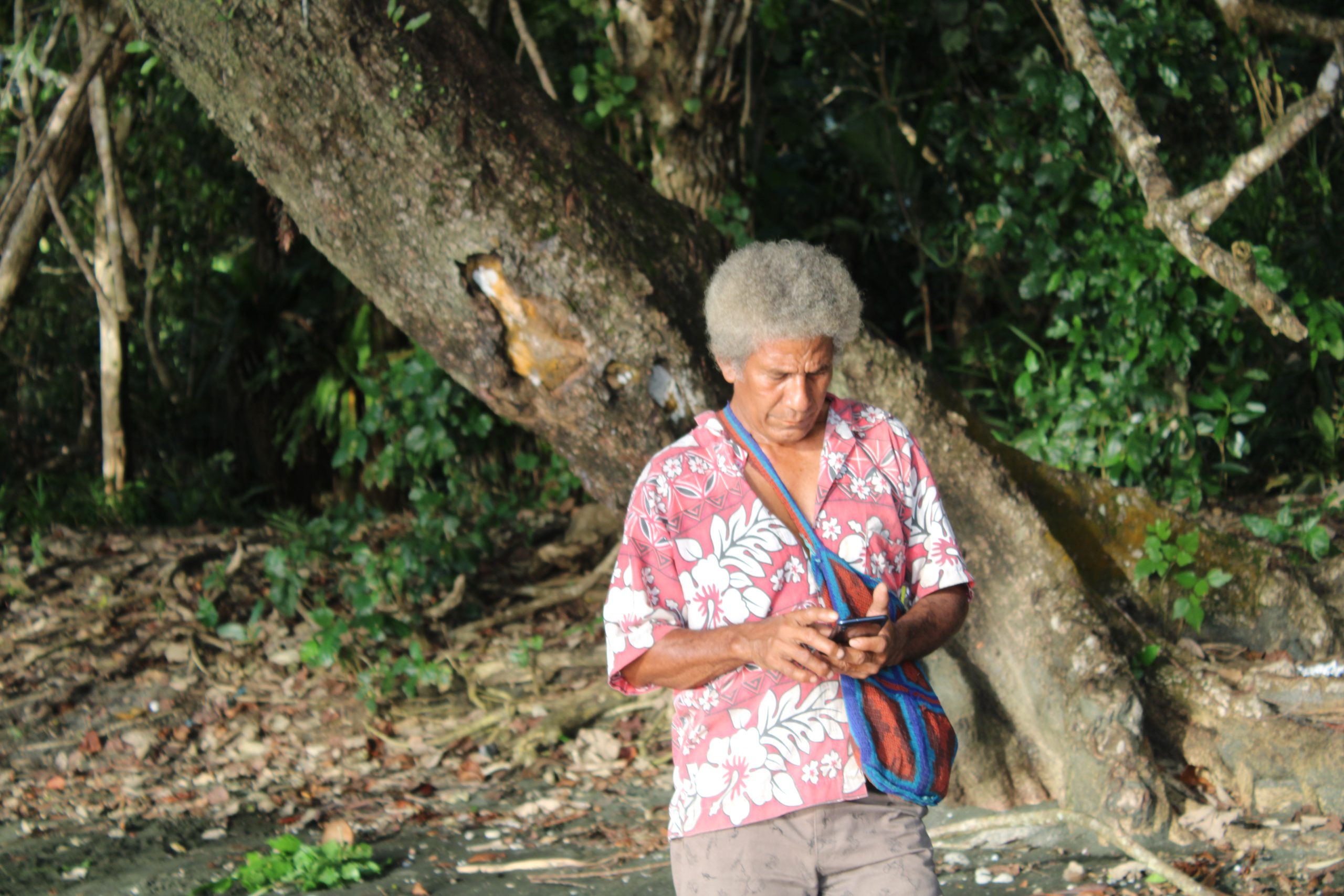 Image of Basil Matasia, a community facilitator in one of Cool Earth's Papua New Guniea community partnerships, collecting data on mobile app.