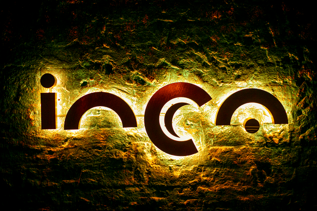 INCA logo, the letters are dark, but dramatically but dramatically back lit on the restaurant wall.