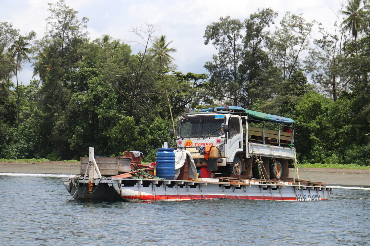 Water tanks and materials being transported by truck and boat to the Wabumari village in Papua New Guinea.