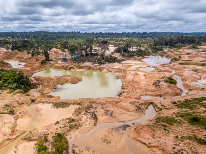 Aerial view of deforested area of the Amazon rainforest caused by illegal mining activities in Brazil. Deforestation and illegal gold mining destroy the forest and contaminate the rivers with mercury.