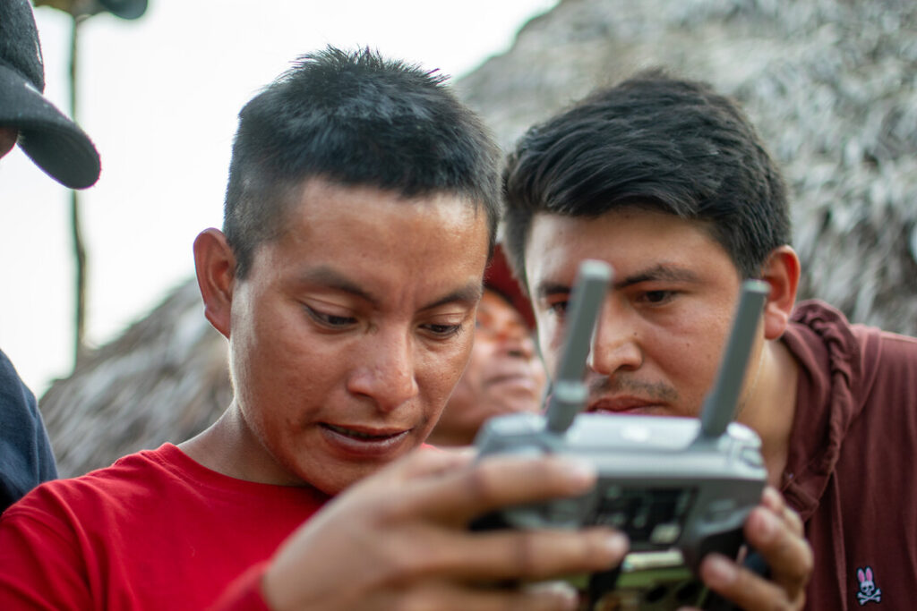 Ashaninka community members being taught how to use drones to monitor their forest for fires. 