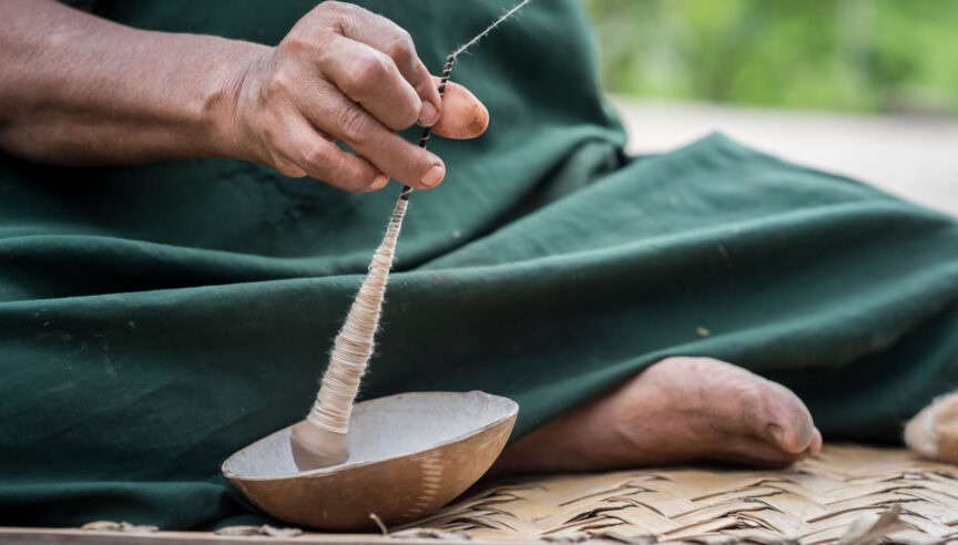 A close up of a person weaving.