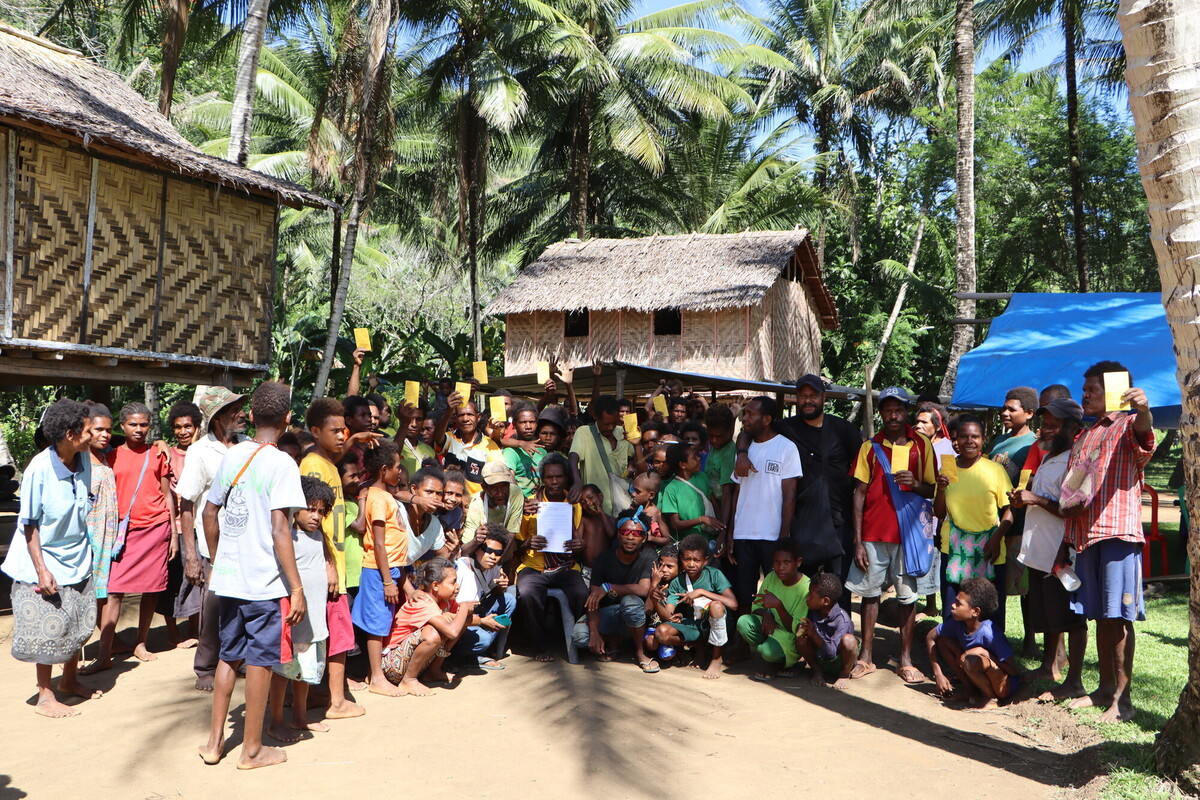 The community of Kondu receiving their first payments as part of their partnership with Cool Earth.