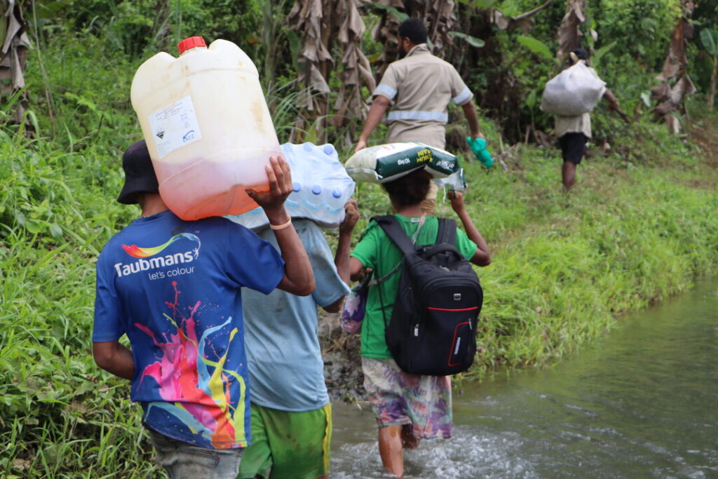 The team carrying essential supplies to reach remote communities deep in the rainforest. 