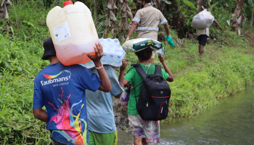 The team carrying essential supplies to reach remote communities deep in the rainforest.