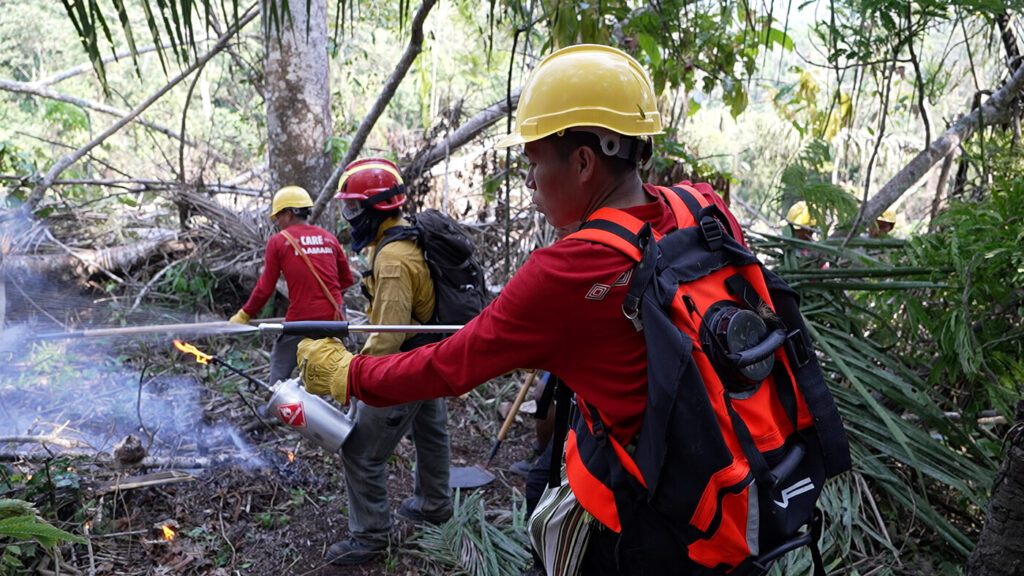 PAAMARI brigade members using fire control tools during a controlled burn exercise.