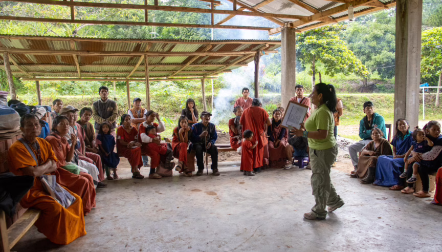 Peruvian community members listening to speaker at their Basic Income Annual Evaluation workshop.
